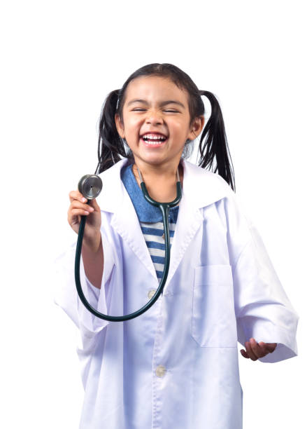 Smiling little girl playing doctor and holding stethoscope stock photo