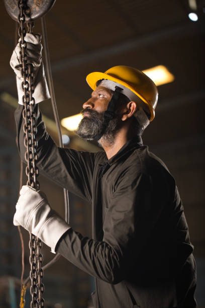 istock Male engineer adjusting chain hoist at industry 1264313273