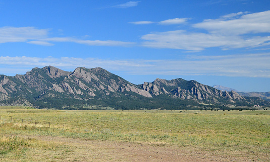 Boulder, CO, USA, July 26th, 2020: The famous Flatirons just west of Boulder, Colorado serve as a dramatic Backdrop for the \n well known Colorado city. The Flatirons are are geologic landmark of Colorado's Front Range.