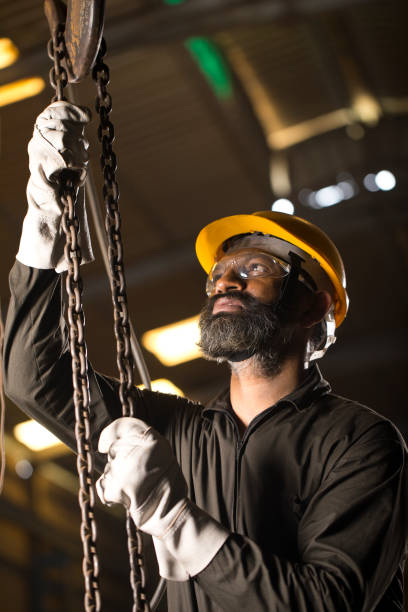 istock Male engineer adjusting chain hoist at industry 1264313476