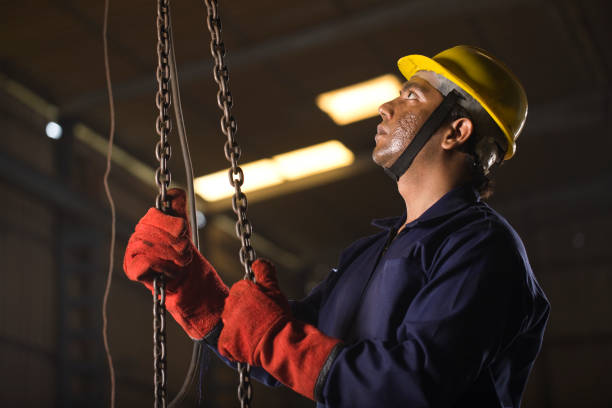 istock Male engineer adjusting chain hoist at industry 1264314786