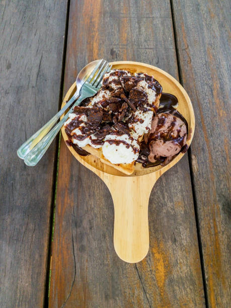 istock Ice cream with cookie on wooden plate 1264315217