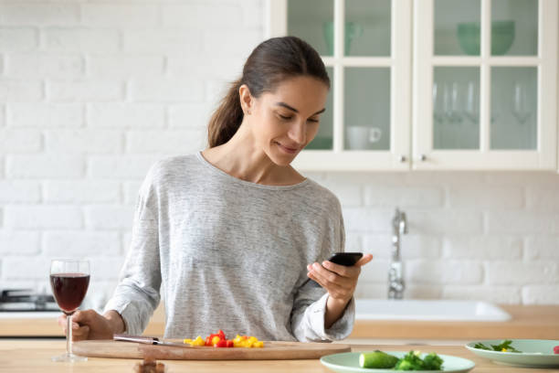 istock Millennial girl cooking using recipe on cellphone 1264315283