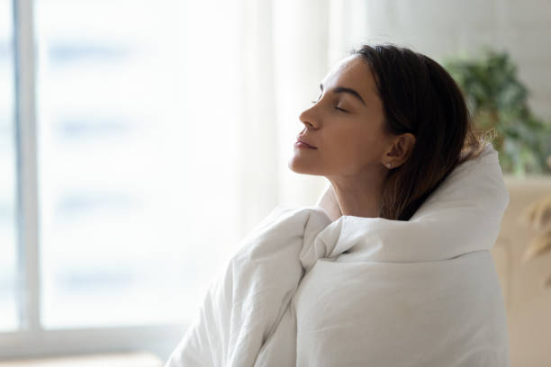Young woman relax ta home warming up in blanket