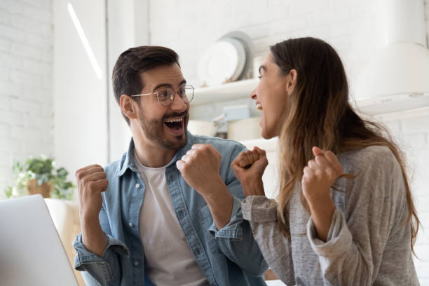 istock Overjoyed couple feel euphoric winning lottery on laptop 1264315840