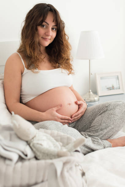 istock Pregnant woman touching her belly 1264319261