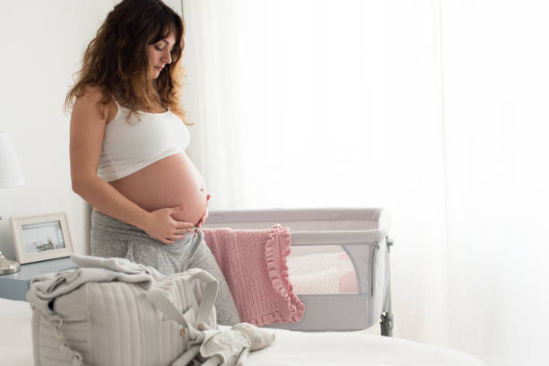 istock Pregnant woman touching her belly 1264319294