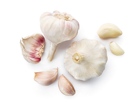 Fresh garlic bulbs and cloves isolated on white background. Top view.