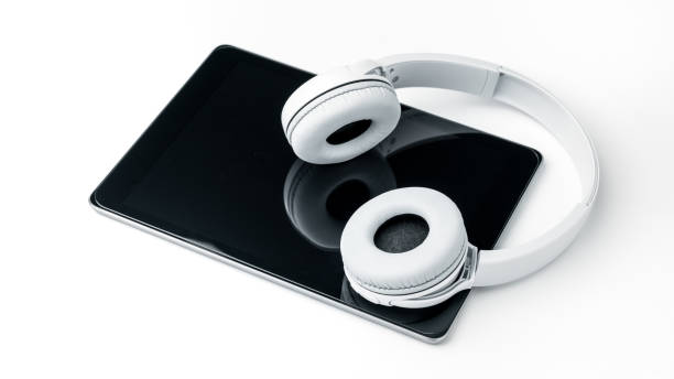 istock White Wireless Headphone with tablet on isolated white background. Entertainment Accessory 1264320808