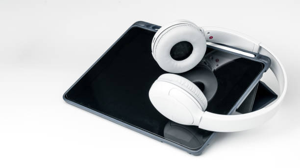 istock White Wireless Headphone with tablet on isolated white background. Entertainment Accessory 1264320819