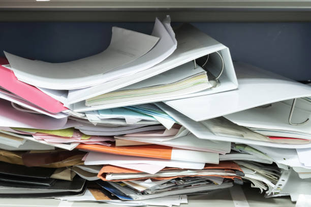 istock Messy file document and Office Supplies in filing cabinets at work office 1264321956