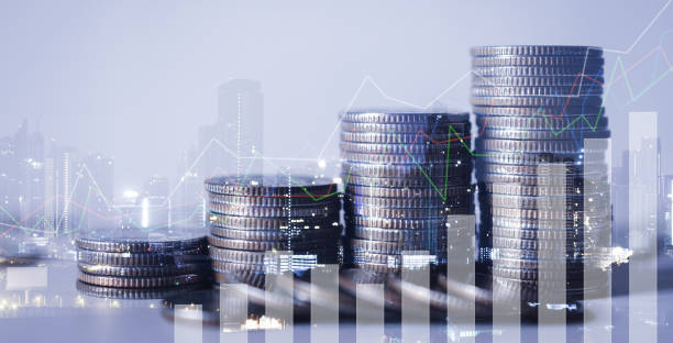 istock double exposure of city with row of coin stack with growth chart and graph progress report for business investment finance banking and money saving concept. 1264322501