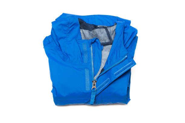 Folded blue zipper windbreaker jacket, rain proof and waterproof hiking Gore-Tex jacket hoodie. Track jacket sport nylon full zip stock photo
