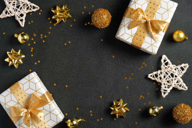 istock Black Christmas background with luxury gift boxes, golden glitter decorations, stars, confetti. Christmas, winter, new year concept. Flat lay, top view, overhead 1264325859