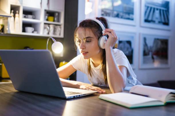 istock Young woman working on the laptop at night 1264325892