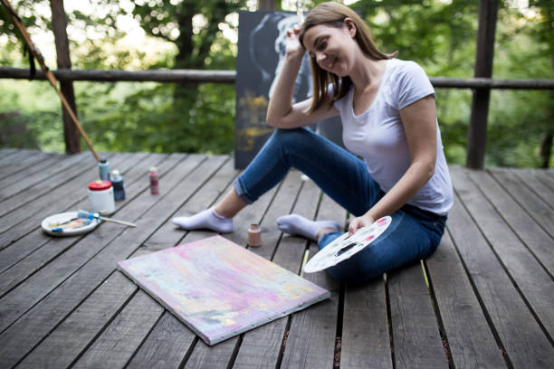 istock Female artist painting on canvas 1264325971