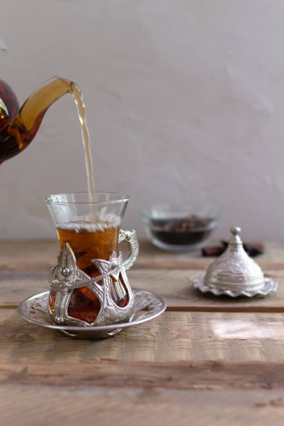 istock Turkish tea in a traditional glass cup on a wooden table. 1264326132