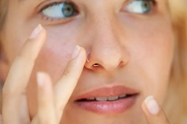 blue eyed girl wearing a nose piercing