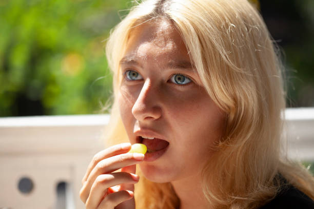 young girl eating grapes