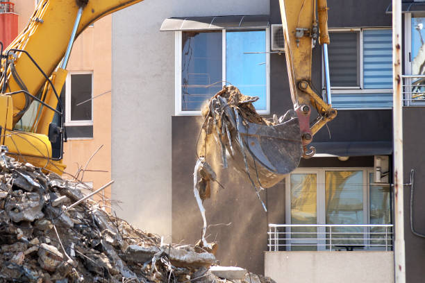 istock an excavator with a bucket breaks an old residential building 1264329604