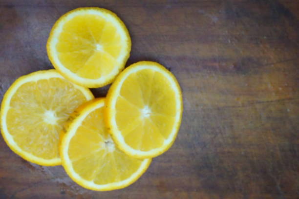 istock Four slices of orange on board 1264329613