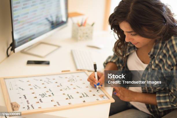 Woman Wrinting On Calendar Stock Photo - Download Image Now - Calendar, Writing - Activity, Women