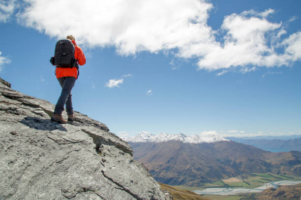 istock Young man hikes up rocky mountain ridge 1264330758