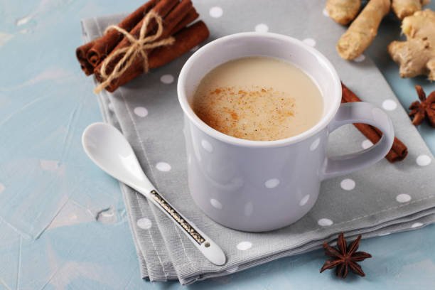 istock Traditional indian masala tea with spices in gray cup on light blue background, horizontal format 1264331296