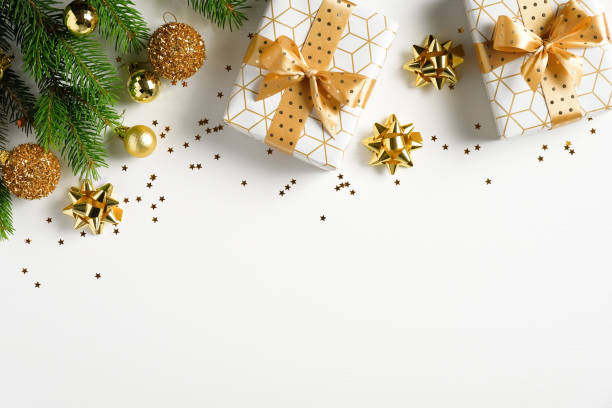 istock Christmas flat lay composition. Top view gold pine tree branch, Xmas decorations, golden balls and gift boxes on white background. Christmas, winter, New Year concept. 1264332133