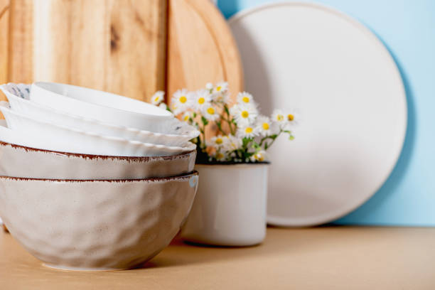istock Bowls, plates and cutting boards on the kitchen table. 1264334733