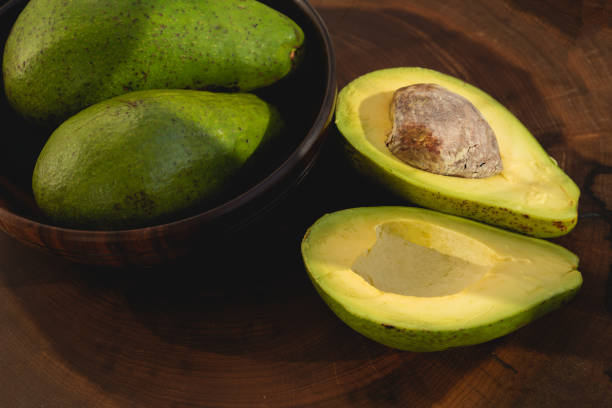 istock avocado butter, sliced on dark wooden background, 1264335667