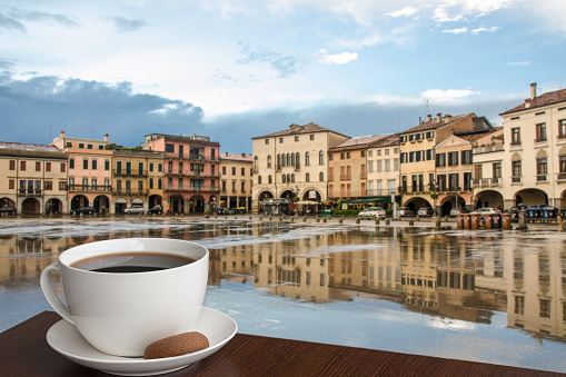 Coffee with cookie on Italian square background in Padova, Italy