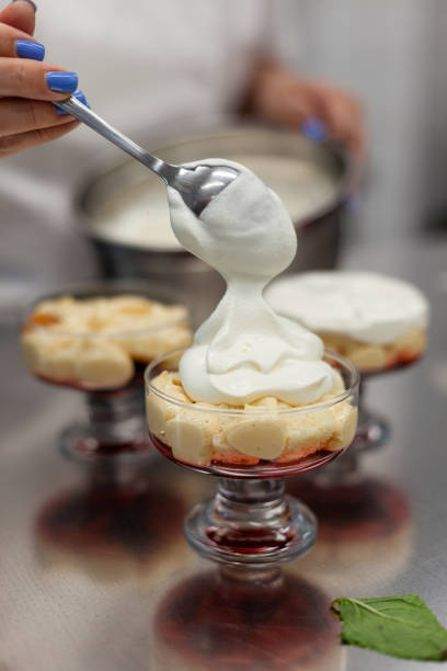 istock The pastry chef pours the cream into portioned forms 1264336832