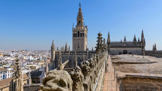 Seville, Andalusia, Spain - October 9, 2019: A close-up view of top of La Giralda, as seen from a narrow pathway at the Central Nave on the roof of Seville Cathedral.