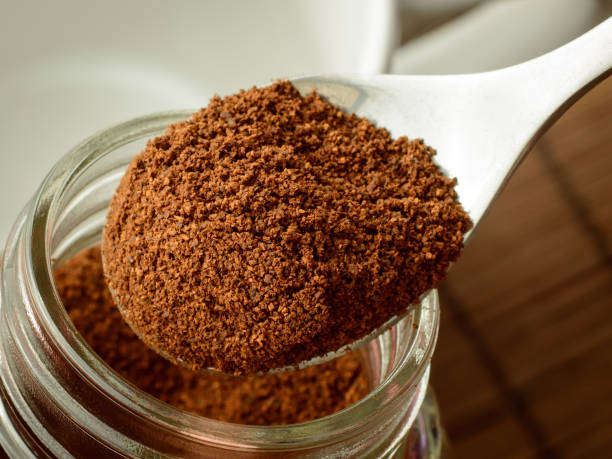 istock Man`s hand taking some ground coffee from coffee jar 1264338108