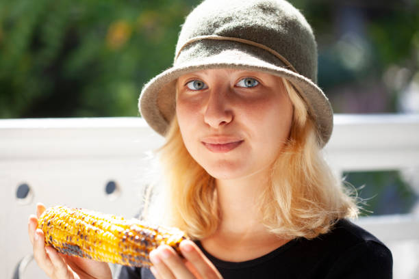 young girl eating corn
