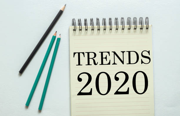 two green one black pencil with text Trends 2020 in the notebook on the white background two green one black pencil with text Trends 2020 in the notebook on the white background escribir stock pictures, royalty-free photos & images