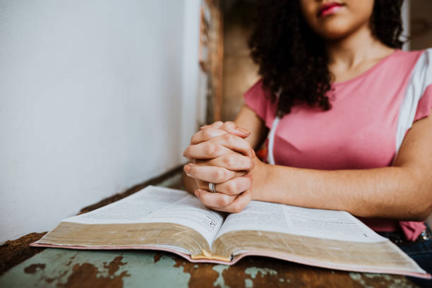 istock Woman with Bible in prayer position 1264344154