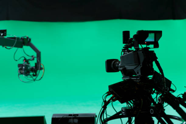 Professional Broadcast studio camera on crane and camera in virtual green studio room with sound equipment on the ceiling. Film Set, Studio - Workplace, Lighting Equipment, Broadcasting, Camera - Photographic Equipment film set stock pictures, royalty-free photos & images