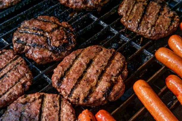istock Grilling Hotdogs Hamburgers 1264348092
