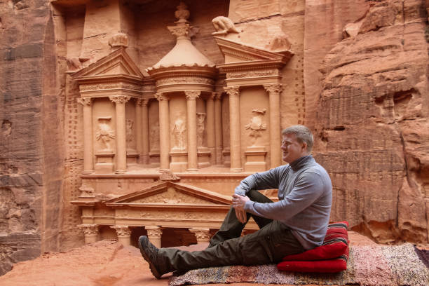 istock Man sits in Petra city, Jordan 1264348112