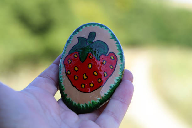 A painted hiking stone is left on the walking path for passersby to see