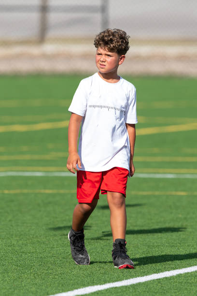 istock Young cute boy playing in a Flag Football game 1264349049