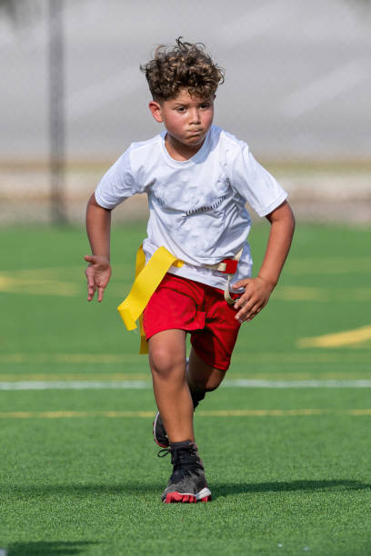 istock Young cute boy playing in a Flag Football game 1264349075