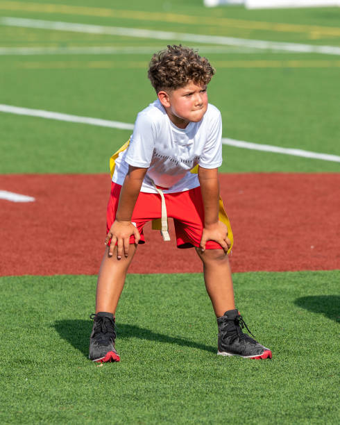 istock Young cute boy playing in a Flag Football game 1264349103