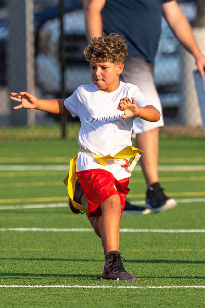 istock Young cute boy playing in a Flag Football game 1264349216