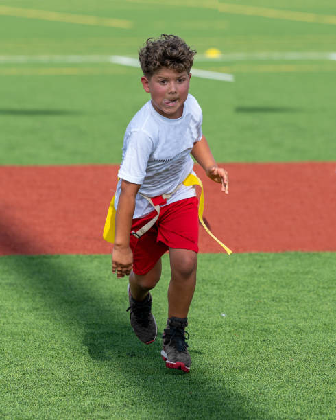 istock Young cute boy playing in a Flag Football game 1264349241