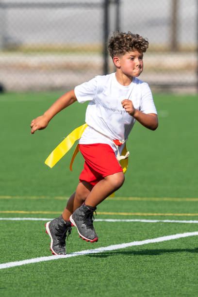 istock Young cute boy playing in a Flag Football game 1264349320