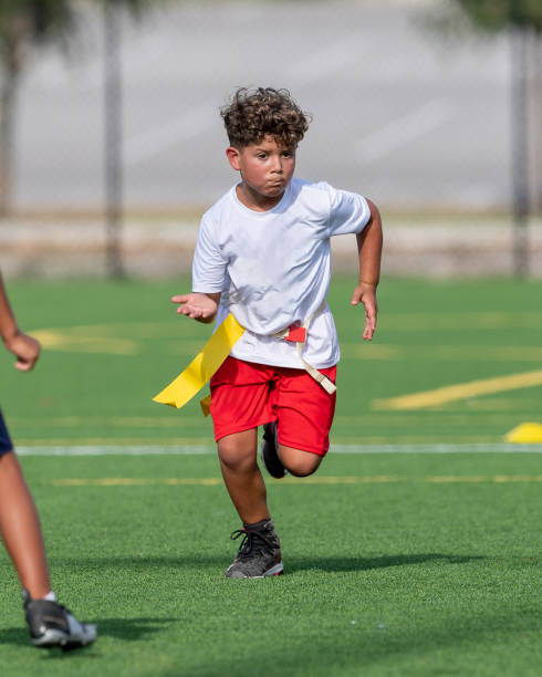 istock Young cute boy playing in a Flag Football game 1264349941