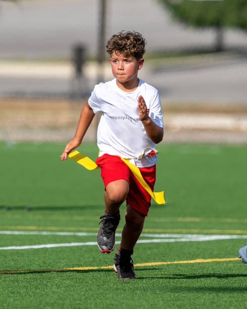 istock Young cute boy playing in a Flag Football game 1264349957